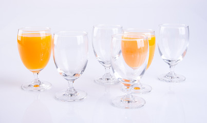 Orange juice in glasses on white background.