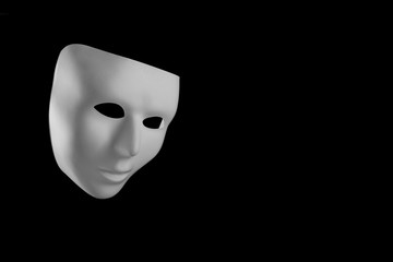 White mask looking down isolated on black background with copy space