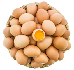 Yolk egg in the shell on eggs in the dry water hyacinth basket isolated on white background, Top view