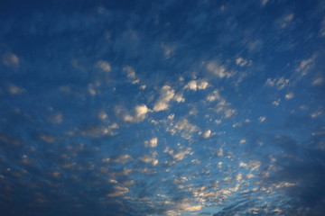 Naklejka na ściany i meble beautiful moving cloud above dramatic blue sunset sky cloudy background