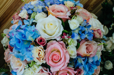 Roses bouquet over wooden table. Top view