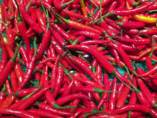 Pile of Red small Chili in the tray. Texture background of red pepper heap.