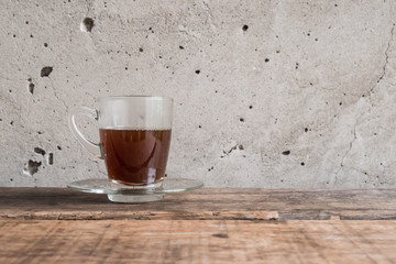 warm cup of coffee wite cement background