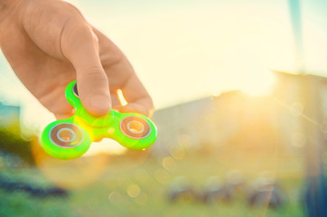 Guy hand holding  trendy popular gadget fidget spinner