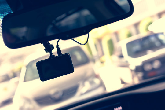 driving car with video camera record technology on windscreen