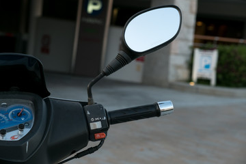 motorcycle scooter. scooter with headlight handlebar and mirrors selective focus.