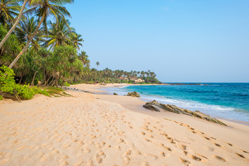 Fototapeta na wymiar The Amanwella beach in Tangalle in the southern province of Sri Lanka. The coastal town has a majestic bay and the most beautiful beaches in the south and south-east 