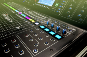 Blurred Hands on the mixing console.