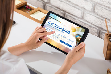Businesswoman Filling The Car Insurance Form On Digital Tablet