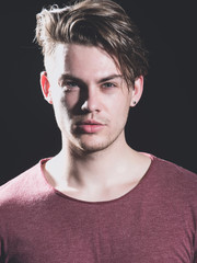 Man with haircut posing on black background