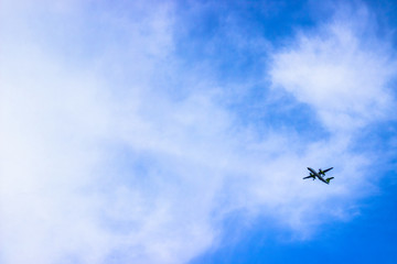 Airplane in the cloudy sky. Travel concept