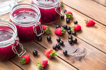 Homemade jam with berries on the wooden table