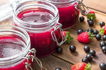 Homemade jam with berries on the wooden table