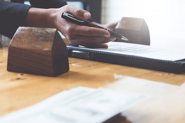 Businessman hand and contract agreement paper with customer to sign contract. Real Estate and...