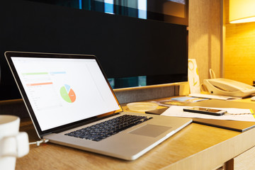 laptop with business report on table