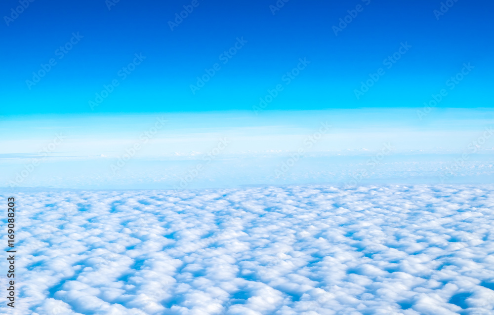 Wall mural blue sky and cloud top view from airplane window,nature background