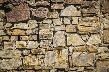 An old stone wall of an ancient fortress close up.