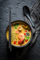 Closeup of Tom Yum soup on black rock