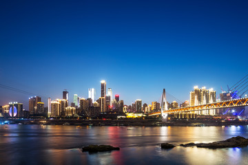 Fototapeta na wymiar cityscape of modern city near water at twilight