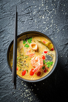 Tom Yum soup with shrimps on black rock
