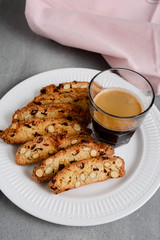 Freshly baked almond and cranberry biscotti and cup of coffee.