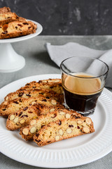 Freshly baked almond and cranberry biscotti  and cup of coffee.