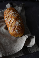 Fresh homemade bread on a black background.