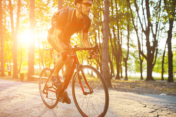 Young man are cycling road bike in the evening