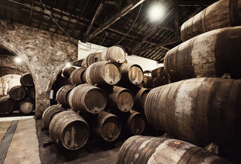 Old wooden barrels in wine cellar