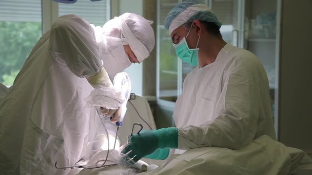 The surgical group of the hospital performs an oncological operation using surgical instruments