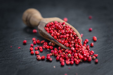 Rustic slate slab with Pink Peppercorns, selective focus