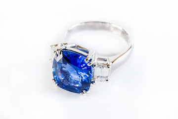 Ring of the jewelry with dark blue sapphire on the White background