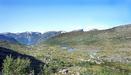 Fototapeta na wymiar Top view of valley between mountains, hiking way to Trolltunga cliff (The Troll's tongue), Odda, Norway