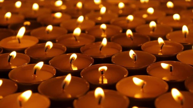 Small candles. Lots of candles with shallow depth. Close-up shot. 