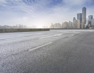 Road pavement and city skyline