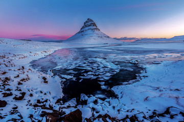 The picturesque sunset over landscapes and waterfalls. Kirkjufell mountain,Iceland