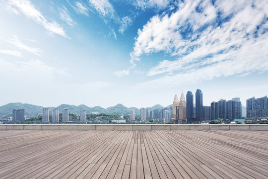 empty wooden floor and cityscape of modern city