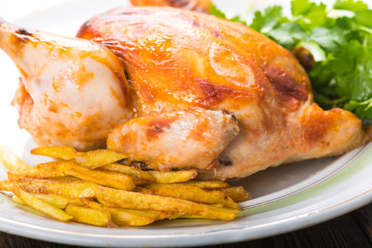 Roasted chicken and potatoes on plate