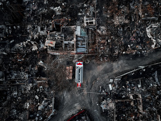 Old home after fire and burned everything in the area. fire truck, top view and Take from drone