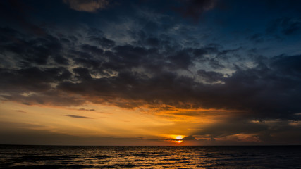 Naklejka na ściany i meble Magic sunset view seascape with beautiful colorful sky, sun and clouds