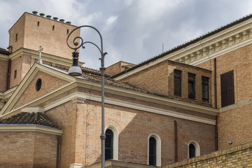 Beautiful old catholic church and street light from wrought iron in Rome, Italy, June 2017