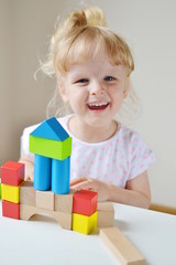Caucasian Girl Playing with Wooden Colorful Cubes at Home Early Education Preparing for School Development