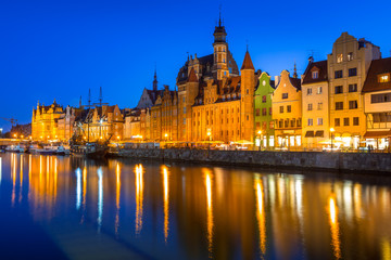 Naklejka na ściany i meble Gdansk at night reflected in Motlawa river, Poland