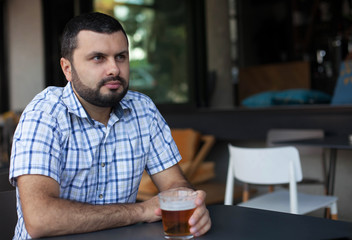 Fototapeta na wymiar Serious man drinking beer