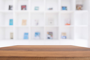 Selected focus empty old wooden table and .Library or Bookstore blur background with bokeh image. for your photomontage or product display