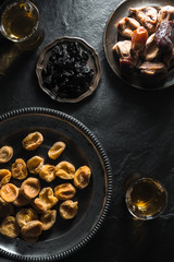 Oriental style tea with dried apricots, dates and raisins on a stone table