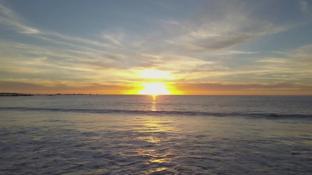 Flying Towards Bright Orange Sunset over the Ocean
