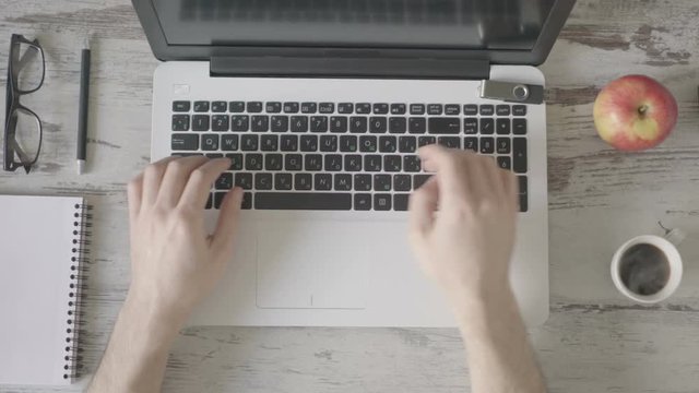 Male hands working on laptop