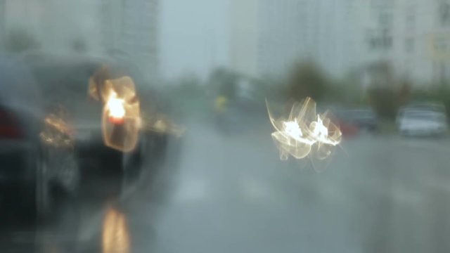 Blurred raindrops on the windshield of the car