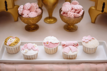 Candy bar. Table with sweets, buffet with cupcakes, candies, dessert.